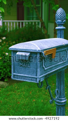Blue empty mailbox on a bright green background