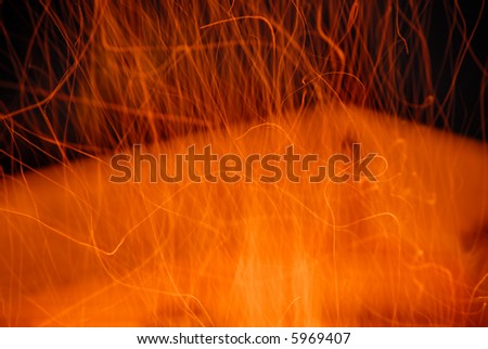 Blurred motion of fire sparks at night. Abstract background