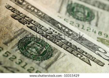 Close up of a twenty dollar bill, country name is in focus. Side lighting - visible texture.