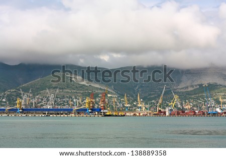 View of the sea port berths with material handling equipment and cargo vessels at anchor