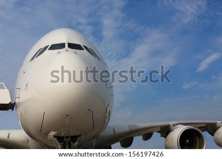 Large passenger jet with the oversight of a ladder, front view