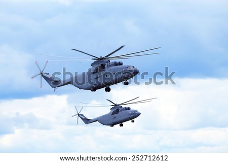 Two modern russian military transport helicopters in flight