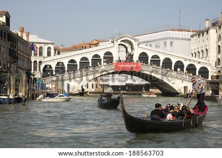 VENICE,ITALY-MARCH 30-The gondolier floats on a gondola with tourists in March 30,2014 in Venice