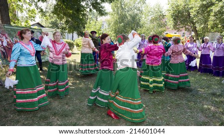 STAROCHERKASSKAYA,ROSTOV REGION, RUSSIA-JULY 26- Cossack family dancing on the lawn in the village under music played Cossack Choir in July 26, 2014 in Starocherkasskaya