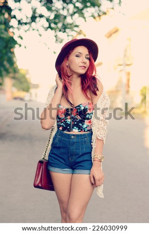 beautiful lady in a summer outfit walking down the street