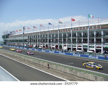 GT race cars crossing the start/finish straight at Magny-Cours circuit, Nevers, France