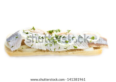 Sandwich with herring, onions and herbs, isolated