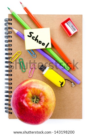 Notebook, red apple  and pencil on white  background. Schoolchild and student studies accessories.