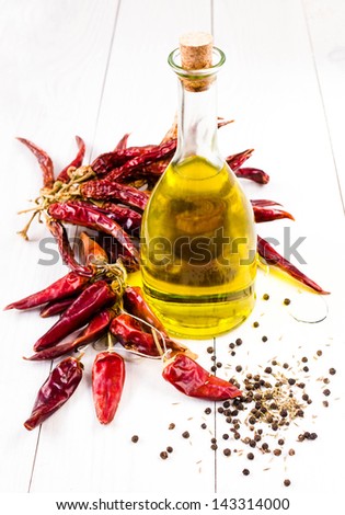 Olive oil bottle and Dried Red hot chili pepper on white