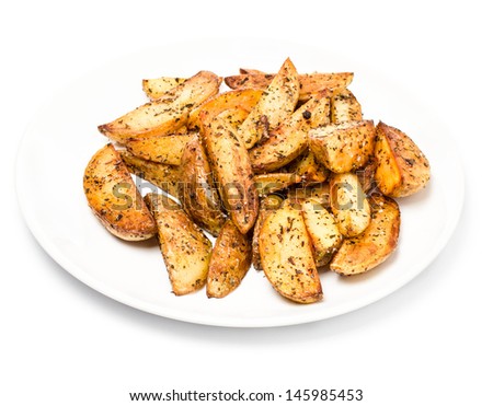 French fries potato wedges in country styled with spices on a plate  on white background. Fast food. Close up.