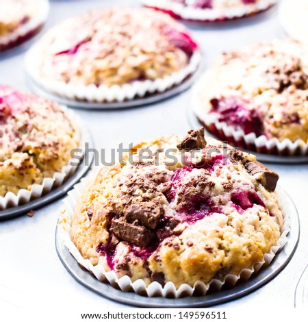 Macro Photo of cakes with mixed berries and chocolate sprinkles in paper container.