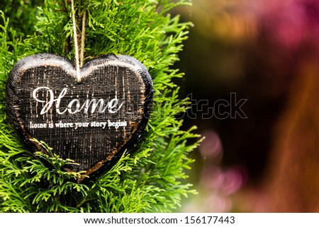 valentine day card concept. Heart shaped decor sign desk Home country style on green fir tree  background.