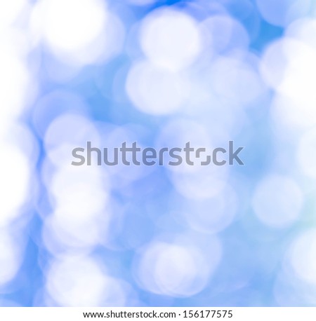 Blue and White Natural Defocused Bokeh lights on a blue gradient background.  Fine art, soft focus, greeting card, festive frame,  shiny wallpaper