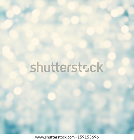Blue Lights Festive background. Abstract Christmas twinkled bright background with bokeh defocused silver lights
