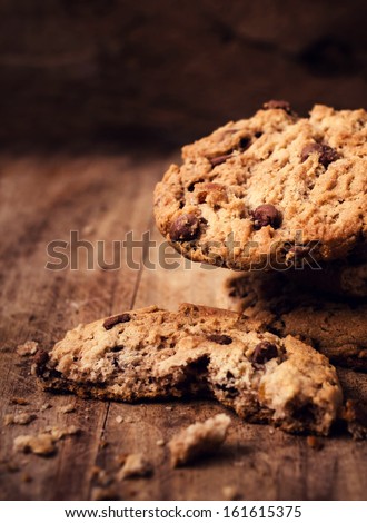 Chocolate chip cookies on wooden table close up. Stacked chocolate chip cookies shot with selective focus.