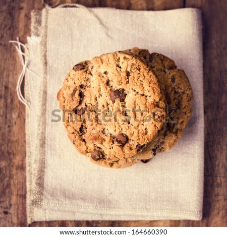 Stacked chocolate chip cookies on linen canvas. Country style. Top Shot.
