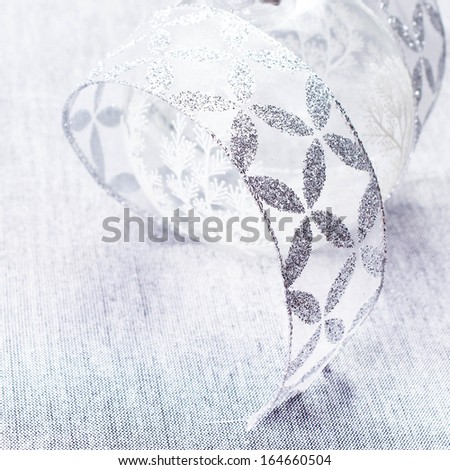 White Christmas. Christmas Decorations with white Ball and silver ribbon close up.