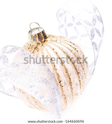 Christmas Decorations with Shiny Christmas Golden ball and silver ribbon isolated on white background, macro. Christmas Ornaments close up.