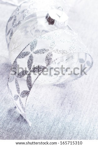 White Christmas. Christmas Decorations with glass  Ball and silver ribbon close up. Christmas card with copy space for greeting text.