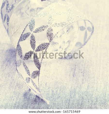 White Christmas. Christmas Decorations with silver ribbon close up. Christmas card with copyspace for greeting text.