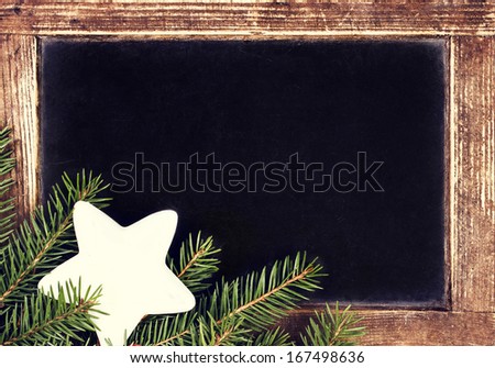 Vintage Blackboard with vintage wooden frame.   Old Fashioned slate chalk board with Christmas Ornaments, Tree Branch and copy space for greeting text.