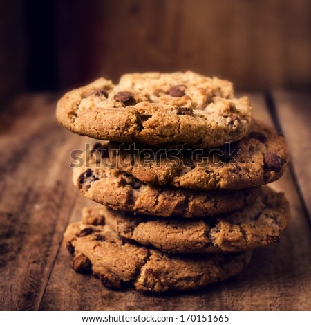 Chocolate cookies on wooden table. Stacked Chocolate chip cookies shot  closeup