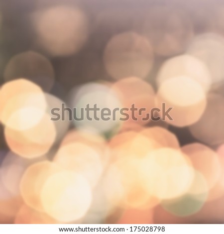 Defocused Bokeh twinkling lights Vintage background. Festive background with natural bokeh and bright golden lights.