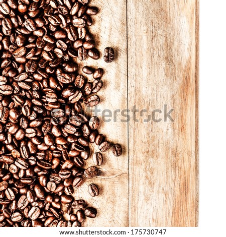 Roasted Coffee Beans background texture on wooden board frame isolated on white background with copy space for text, macro. Fragrant fried coffee beans.