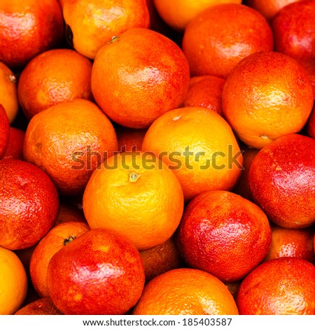 Red Orange fruit background. Pile of Orange fruit in a market stall. Food background.