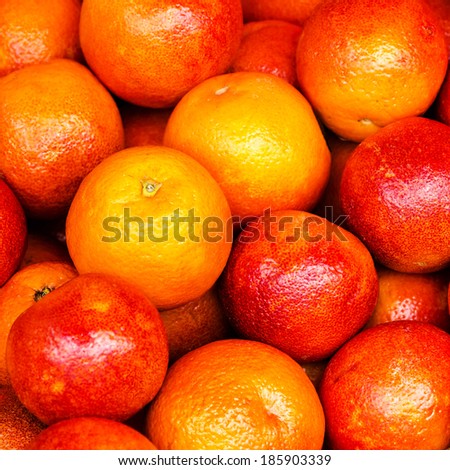 Red Orange fruit background. Pile of Orange fruit in a market stall. Food background.