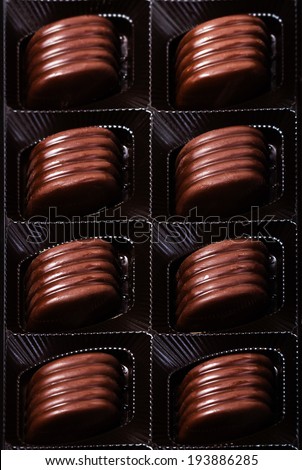 Box of chocolate truffles, close-up, chocolate gift. Various chocolates as a background, top view.