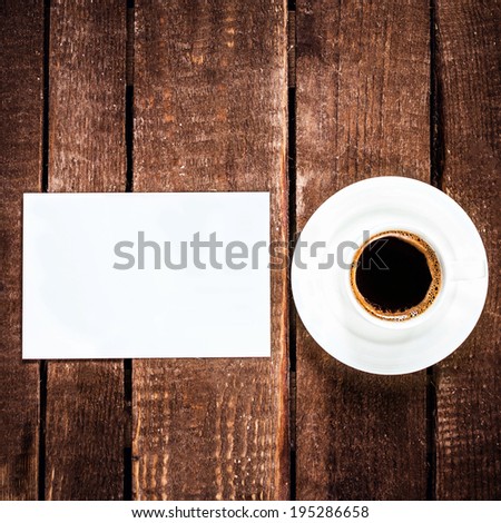 Black Coffee cup and blank business card on wooden table. White Card