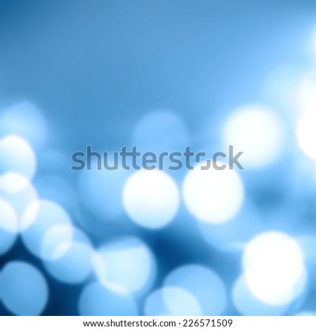 Blue Christmas background with bokeh lights. Defocused Bokeh twinkling Lights Festive holiday party background.