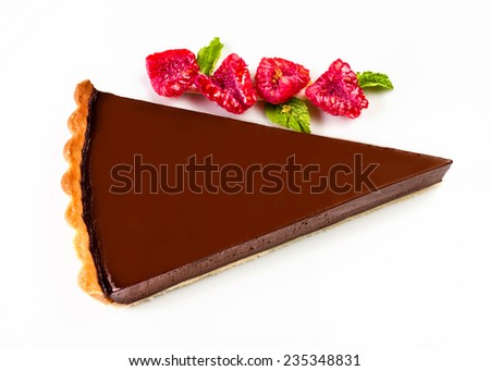 Dark chocolate cake. Slice of chocolate layer cake with red berries and chocolate sauce macro