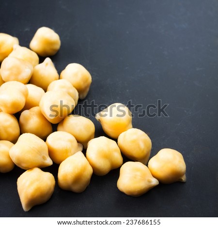 Golden  Chickpeas over black  chalk board  table close up with free blank copyspace for your text.  Traditional Indian Food