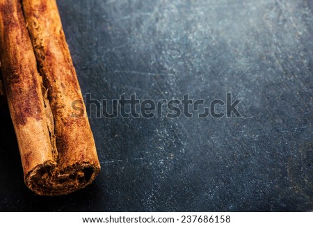 Bunch of cinnamon sticks close up on dark background with blank copyspace for your text