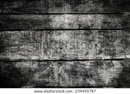 Old  dark  grunge wood background with knots and scratches.