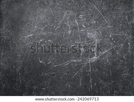 Abstract Gray  background with spotlight and scratches. Dark grunge textured wall closeup for design. Grungy  blackboard.