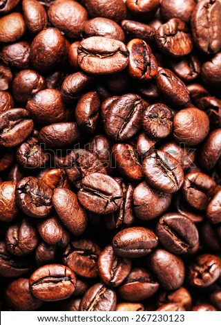 Roasted Coffee Beans background texture. Arabic roasting coffee - ingredient of hot beverage. Brown coffee beans for background and texture.