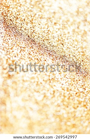 Holiday abstract glitter background with blinking lights and gold defocused texture. Golden Glitter festive bokeh