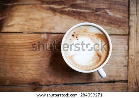 Cup of Coffee  for breakfast on rustic wooden table, top view. Cappuccino over wooden background with copy space for text