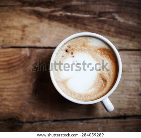 Cup of Coffee  for breakfast on rustic wooden table, top view. Cappuccino over wooden background with copy space for text