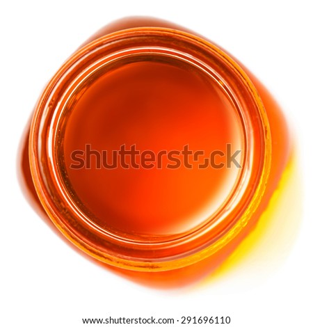 Honey in a glass jar  isolated on white background  close up, top view.
