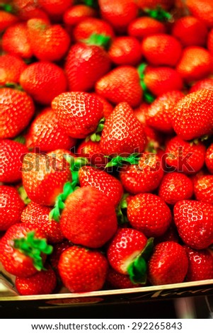 Strawberry  background on a market stall close-up. Food healthy backdrop full frame