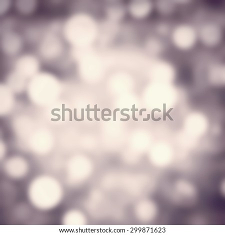 Defocused Abstract Festive background. Glittering lights background with silver and grey  light. Christmas and New Year feast bokeh background with copyspace.