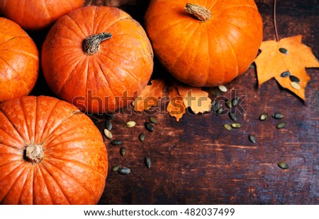 Pumpkin with pieces over wooden table with copy space