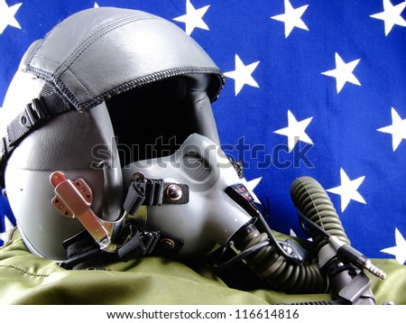 Military pilot helmet set against a vintage vivid cloth American flag