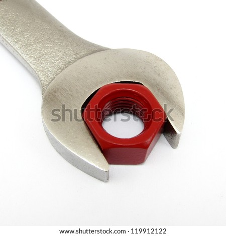 Concept of perfect fit.  Using a red hexagon nut and wrench to convey abstract theme.