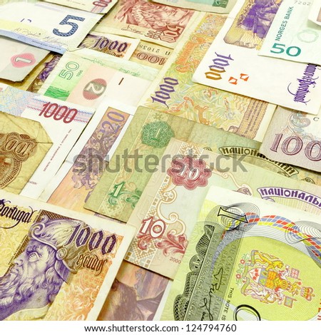 Arranged foreign currency and money with denomination of each note visible.