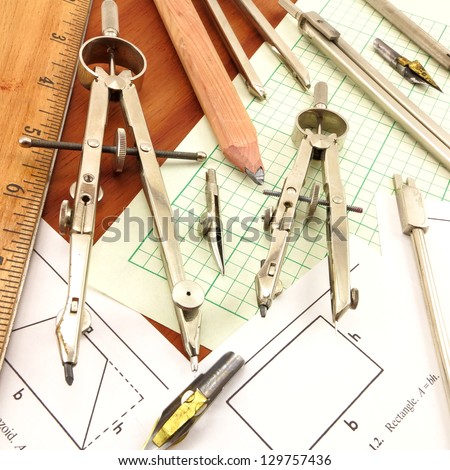 Design Time.  Conglomerate of antique drafting tools on engineering paper and wood background.